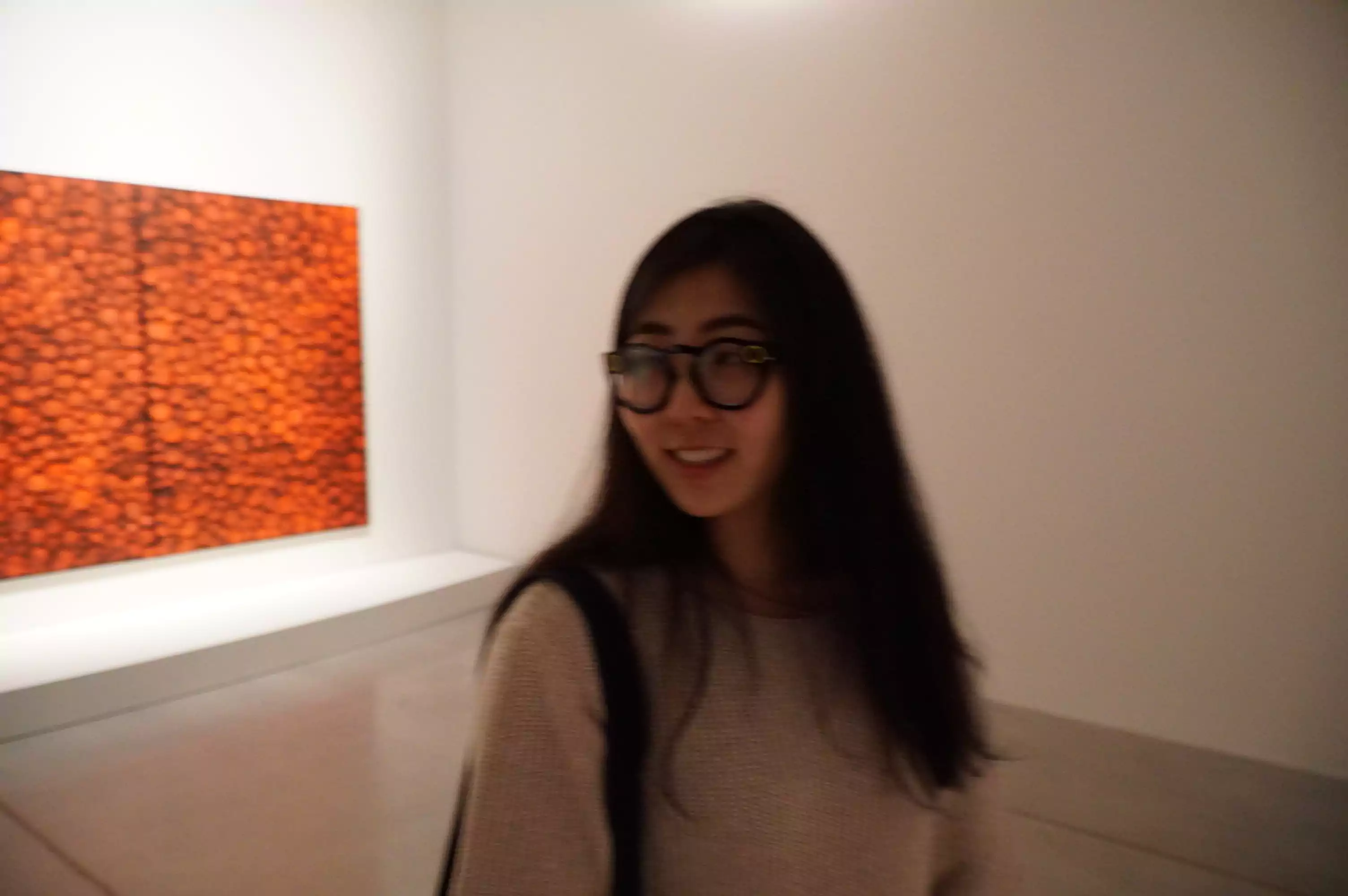 Blurry image of a girl wearing Snapchat Spectacles with the sunglass lenses replaced with prescription ones, looking off from the camera in an artistic way